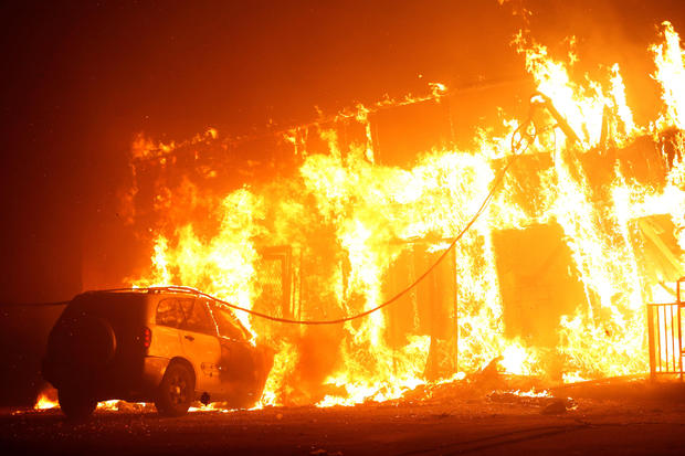A structure is seen engulfed in flames during the Camp Fire in Paradise
