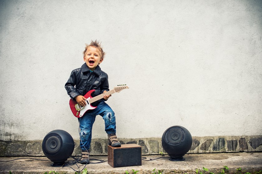 Little boy playing electric guitar
